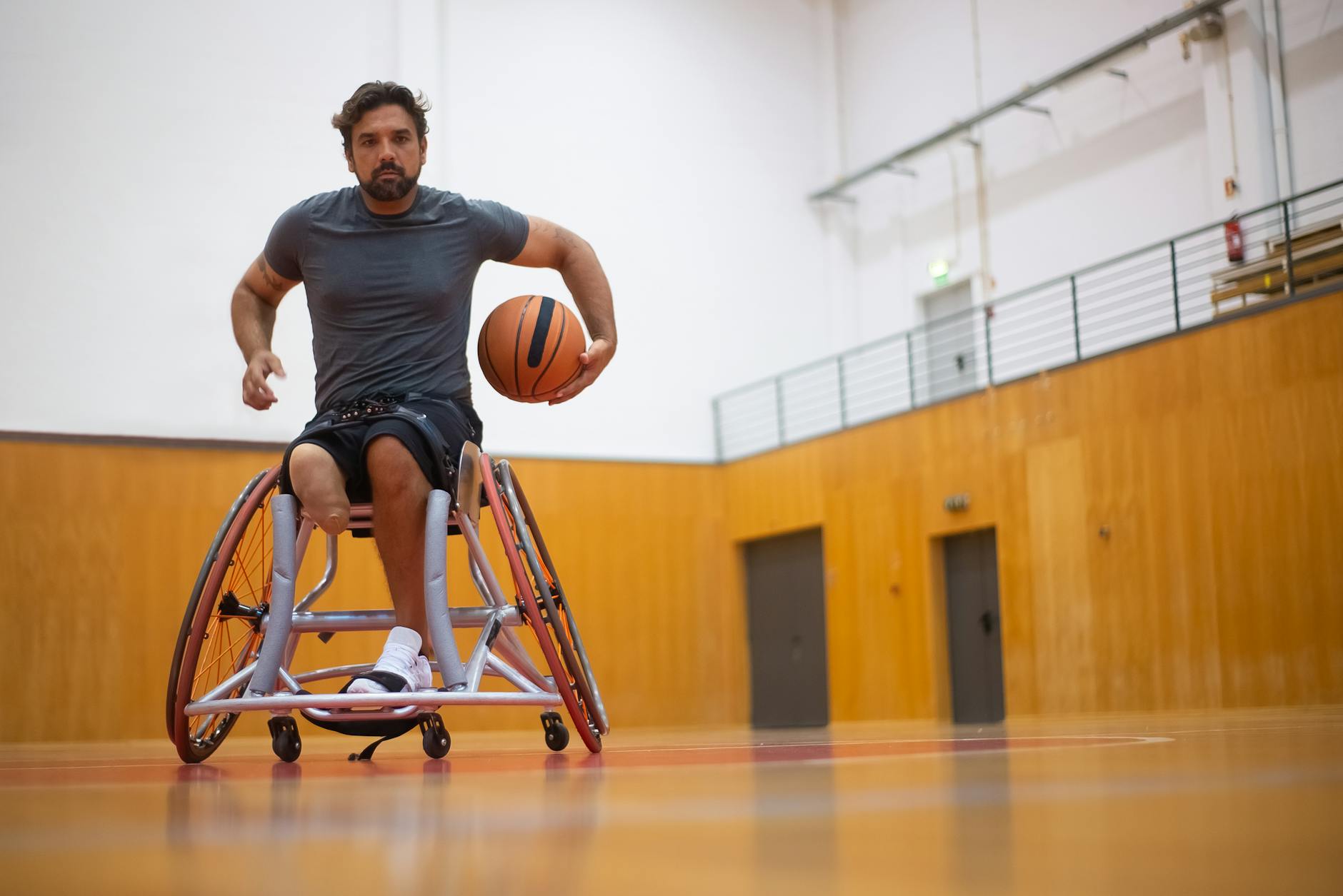 Program Activities for Adults with Disabilities displays a man in a wheelchair playing basketball